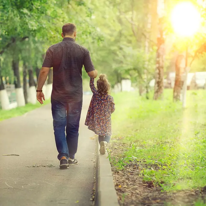 Dad walks with her daughter in the park