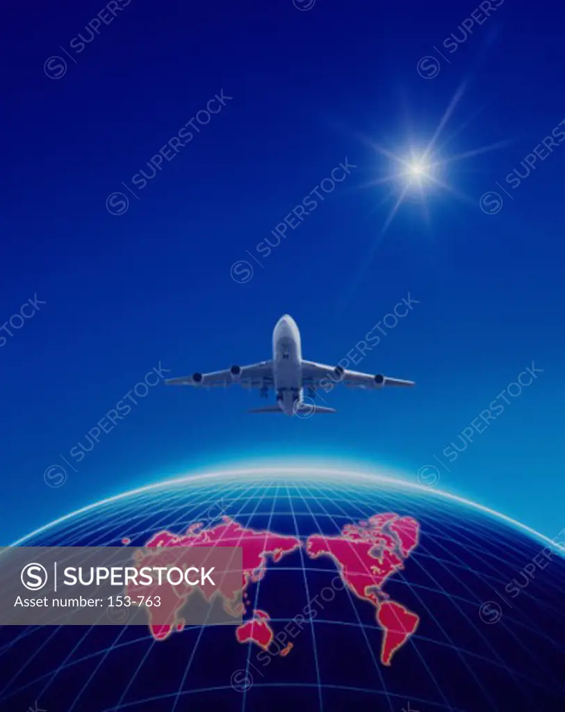 Low angle view of an airplane flying over a globe