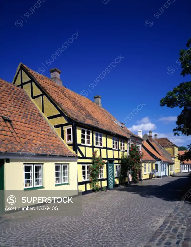 Houses along a cobblestone street, Aero Island, Denmark