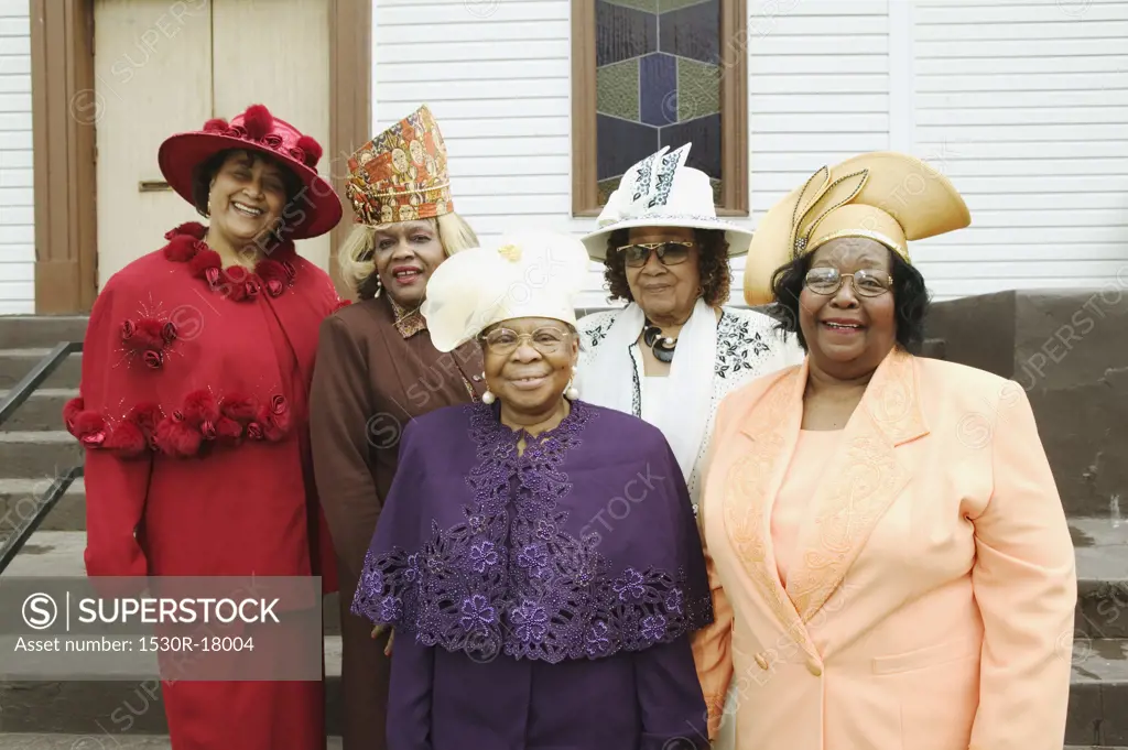 Five senior women wearing hats.