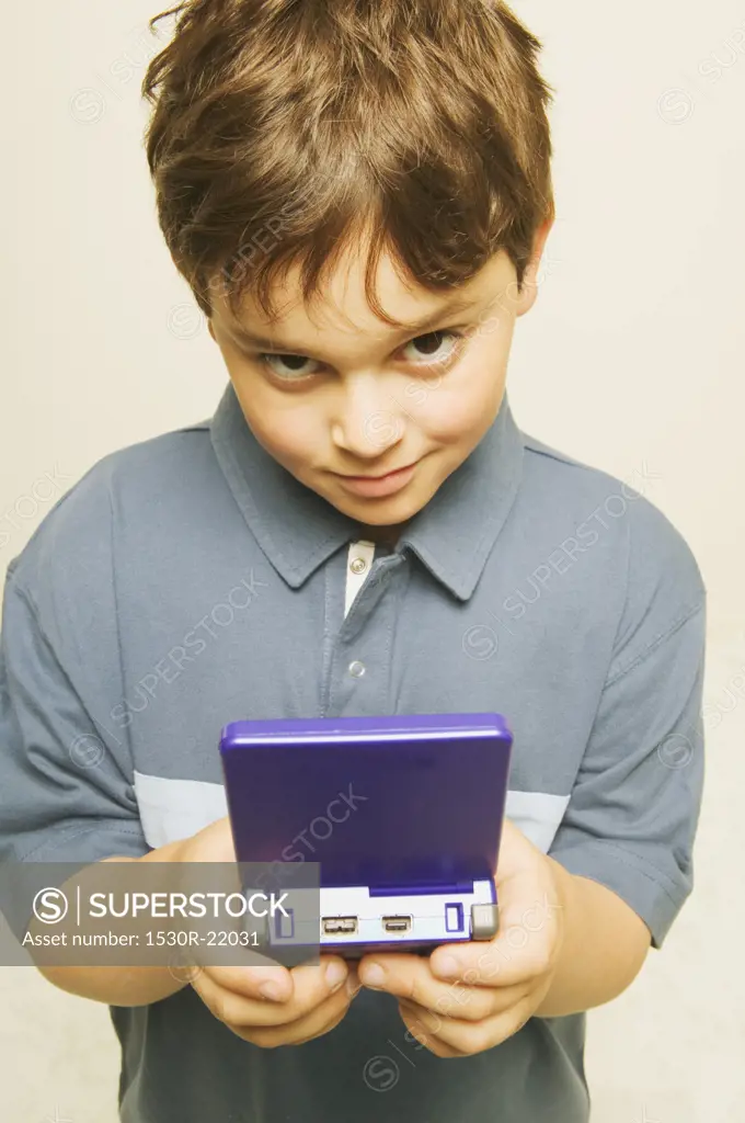 A little boy playing a computerized game