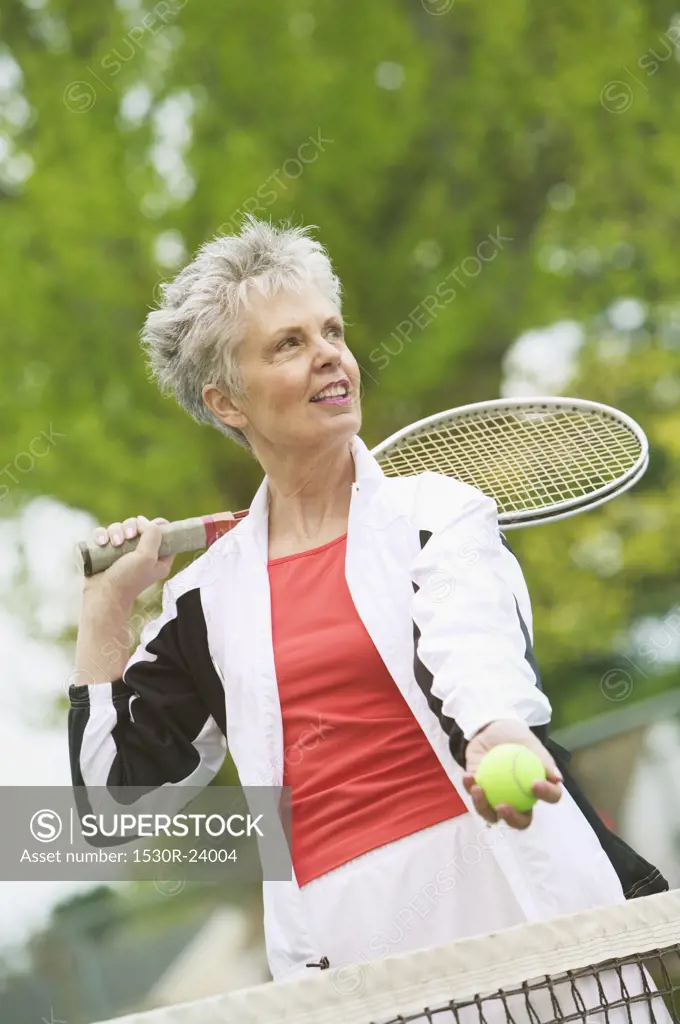 A middle-aged woman playing tennis
