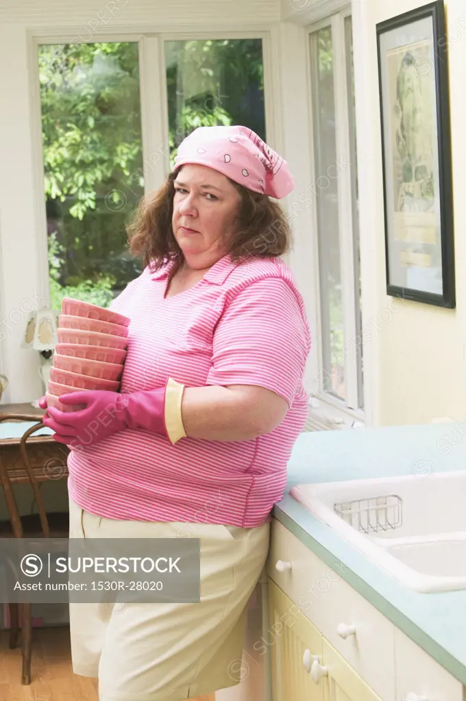 Unhappy woman about to wash dishes