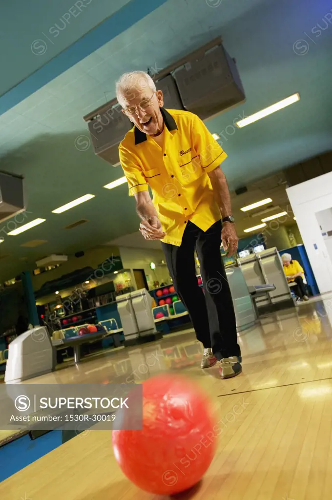 A senior man bowling