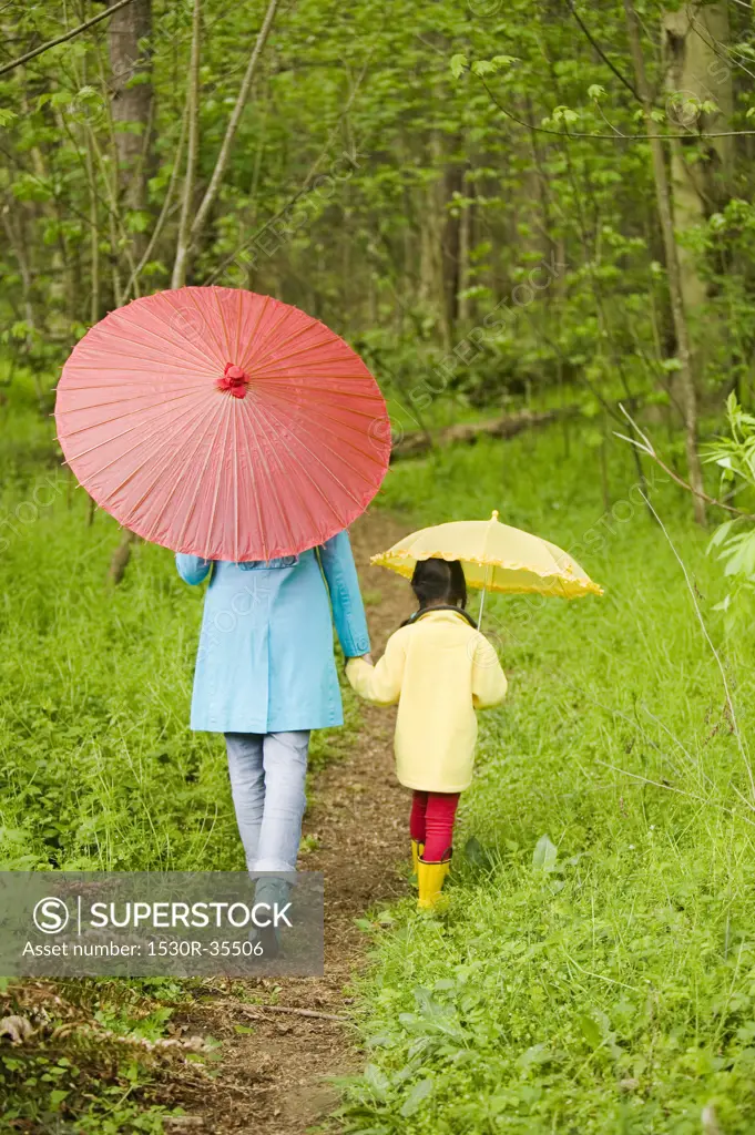 Mother and daughter walking in forest