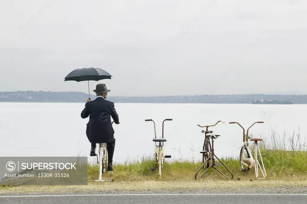 Businessman with row of stationary bikes