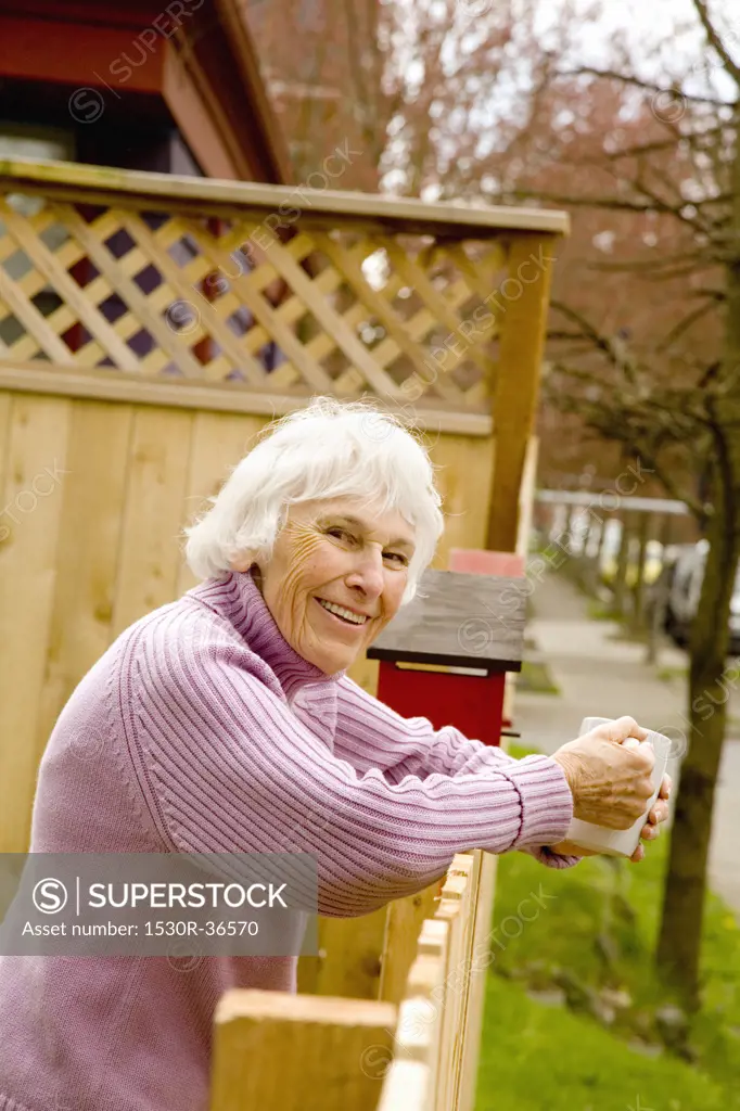 Portrait of senior woman holding mug