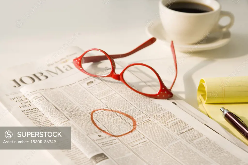 Close up of glasses on classified ads