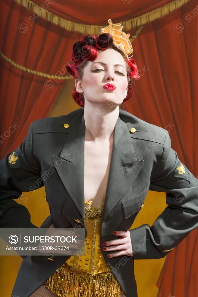 Woman wearing military jacket and blowing kiss