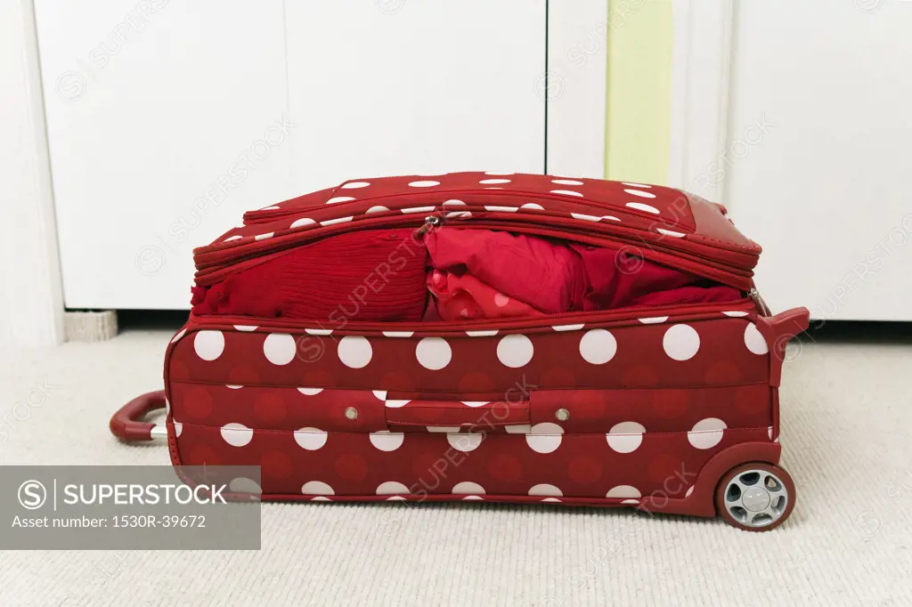 Red polka dot patterned suitcase