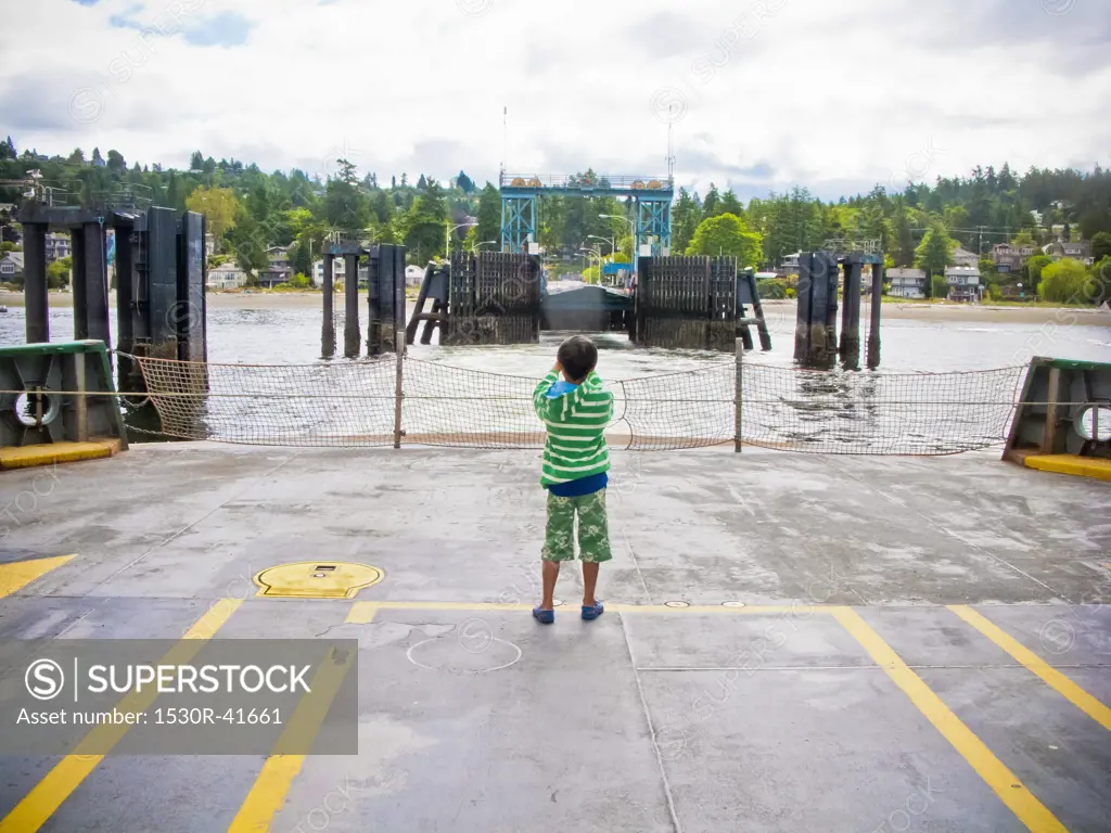 Boy standing on car deck of ferry,  Puget Sound, Washington USA