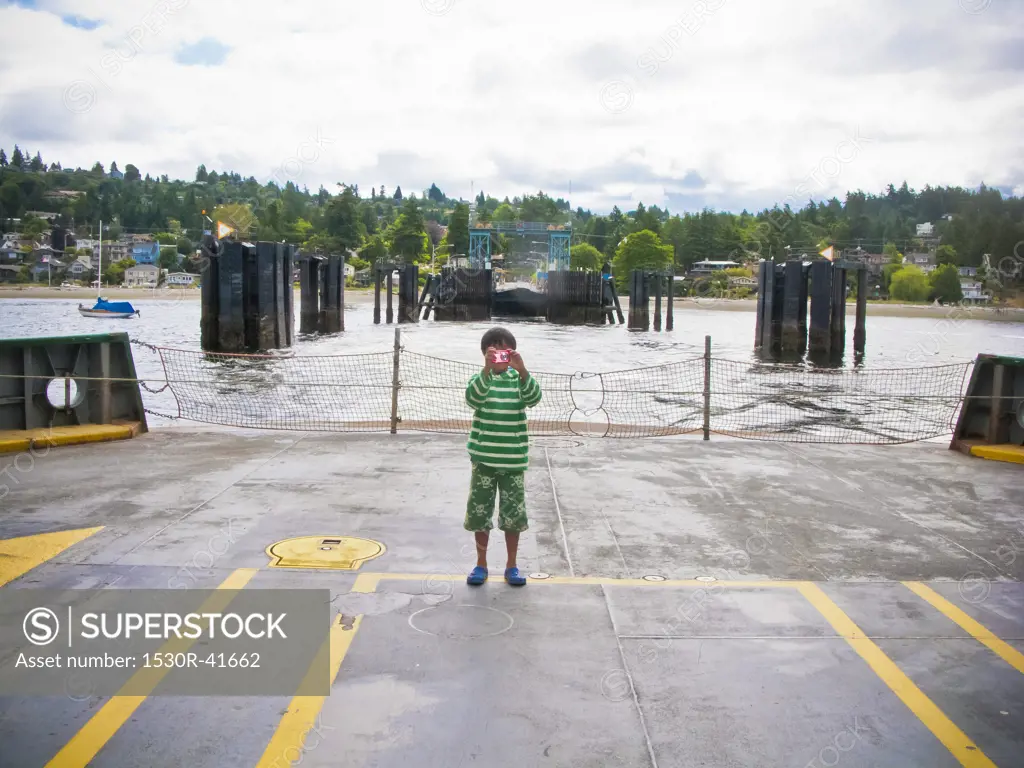 Boy standing on car deck of ferry,  Puget Sound, Washington USA