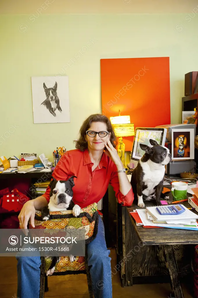Woman at home office desk with dogs