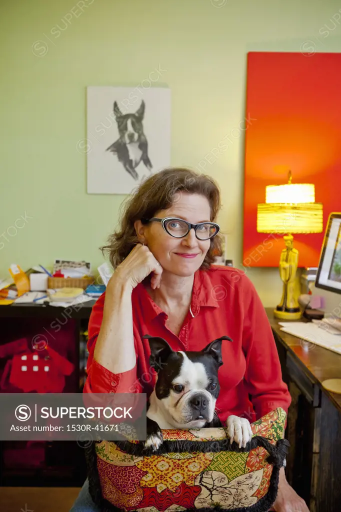 Woman at home office desk with dog