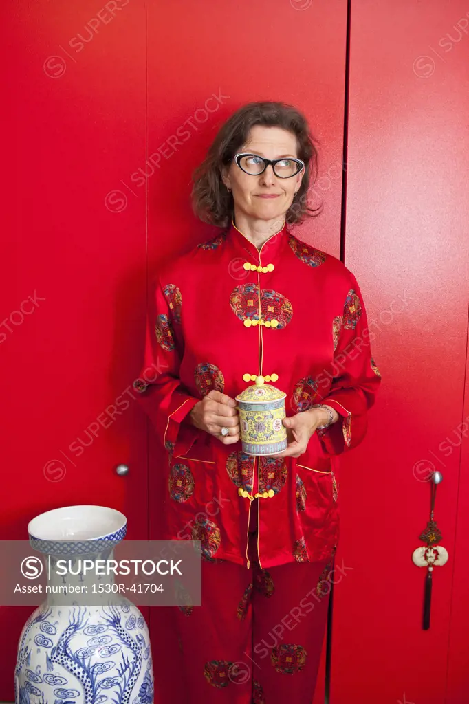 Woman wearing red silk Chinese pajamas,