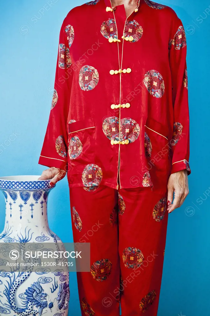 Woman wearing red silk Chinese pajamas,