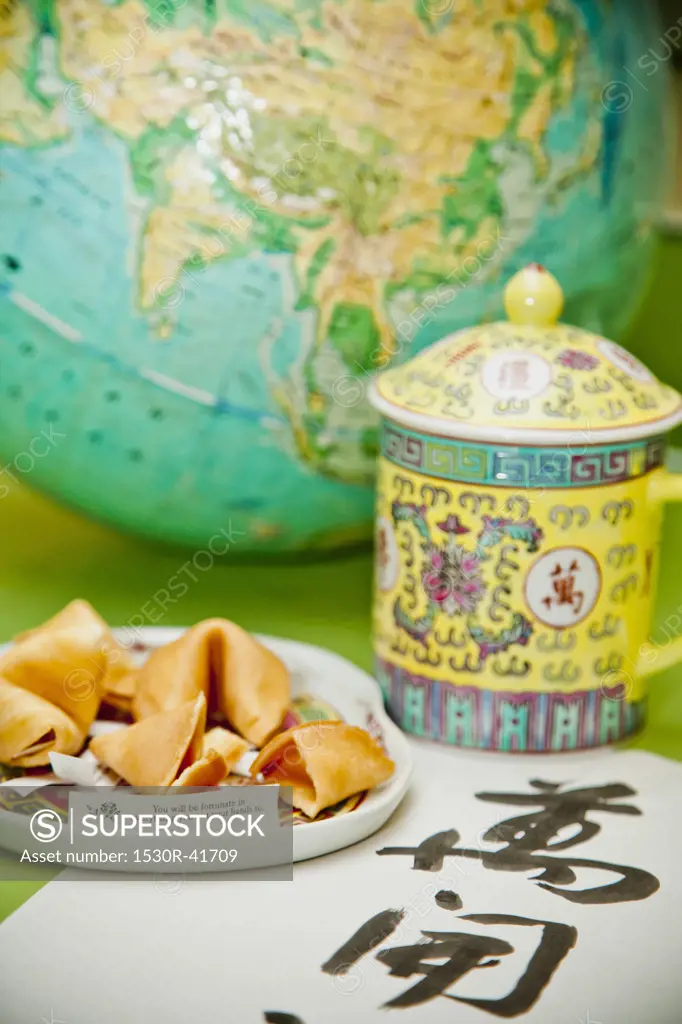Still life with fortune cookies and globe,