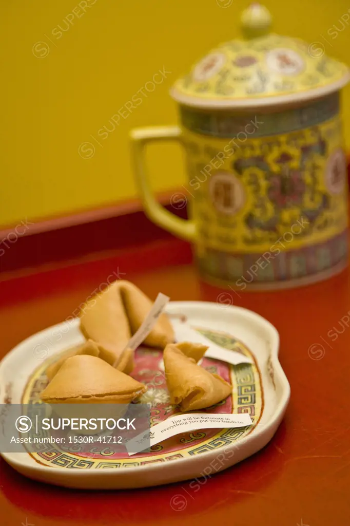 Plate of fortune cookies and tea mug,