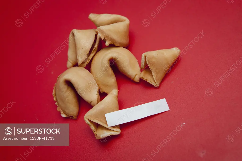 Fortune cookies on red surface,