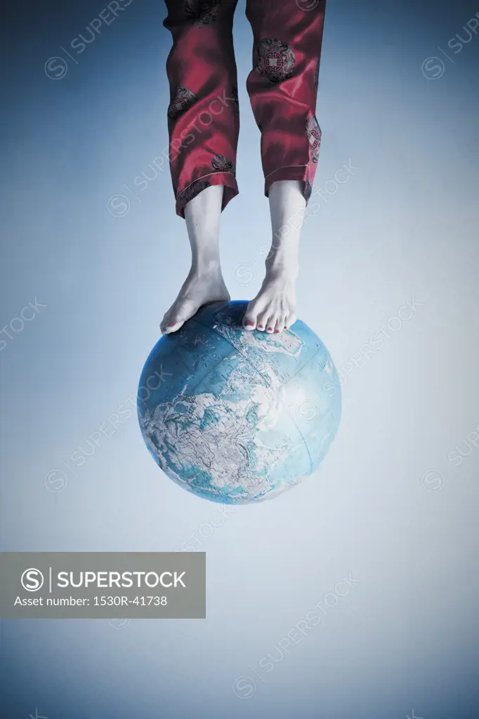 Feet and legs on globe,