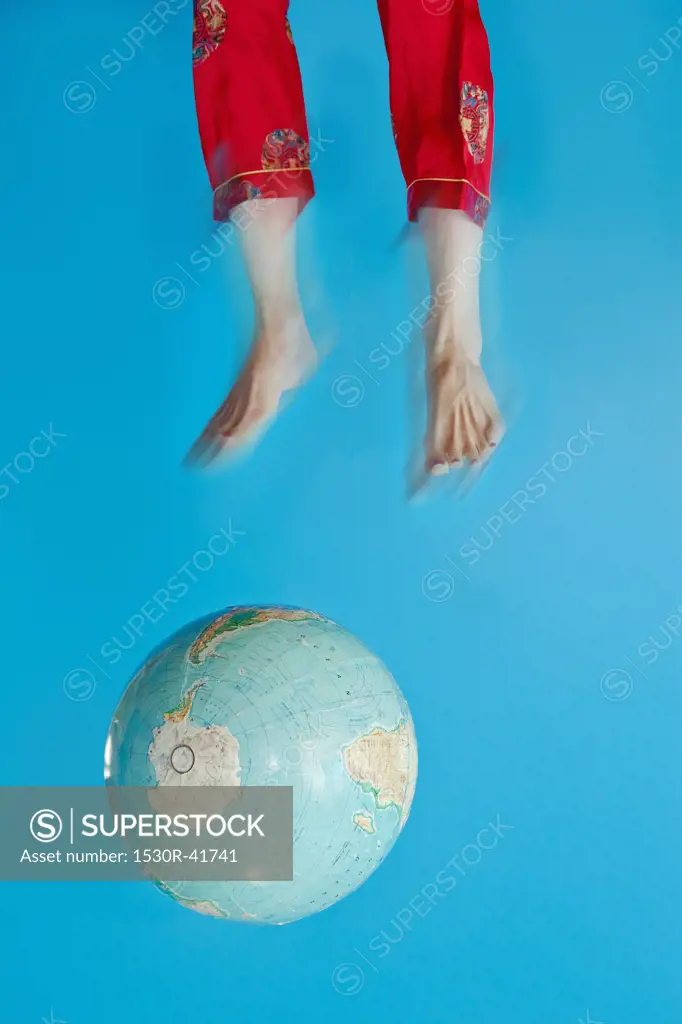 Globe and feet in air,