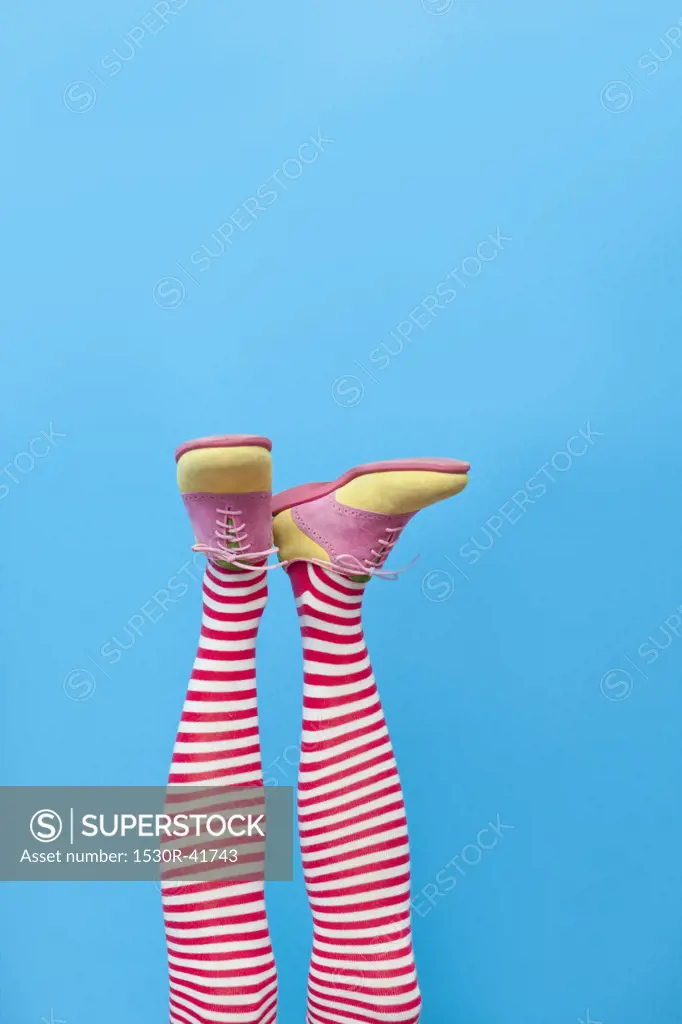 Legs in striped socks with colorful shoes,