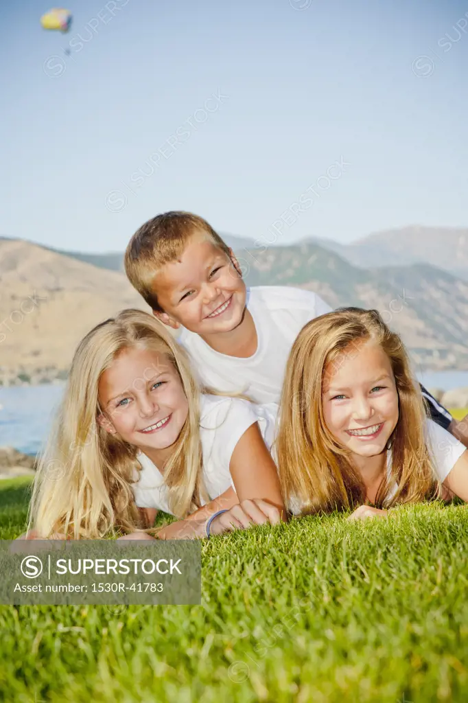 Outdoor portrait of three young children,