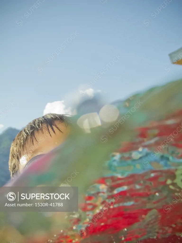 Boy coming up out of water,