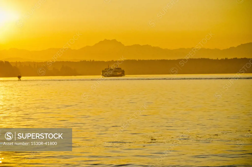 Washington state ferry at sunset with Olympic mountains,  Puget Sound, Washington, USA