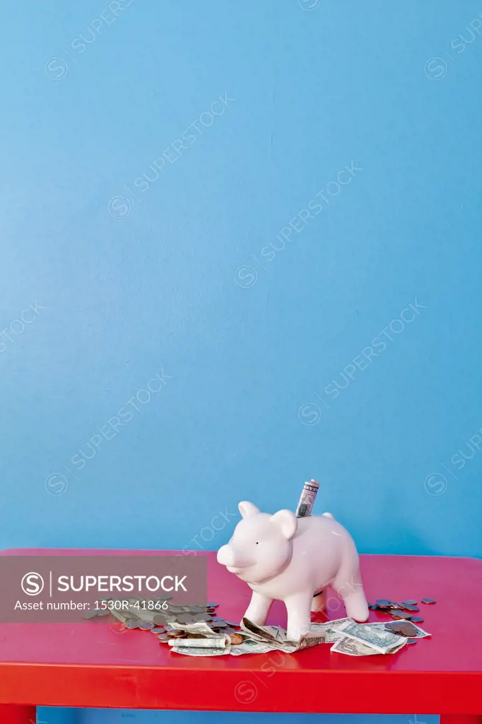 Piggy bank on red table,