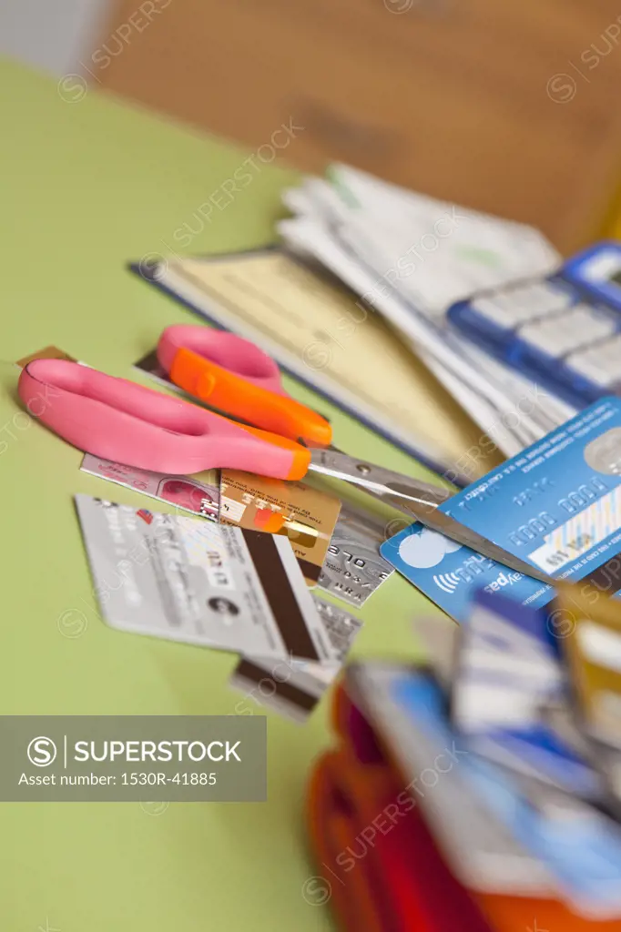 Scissors cutting up credit cards