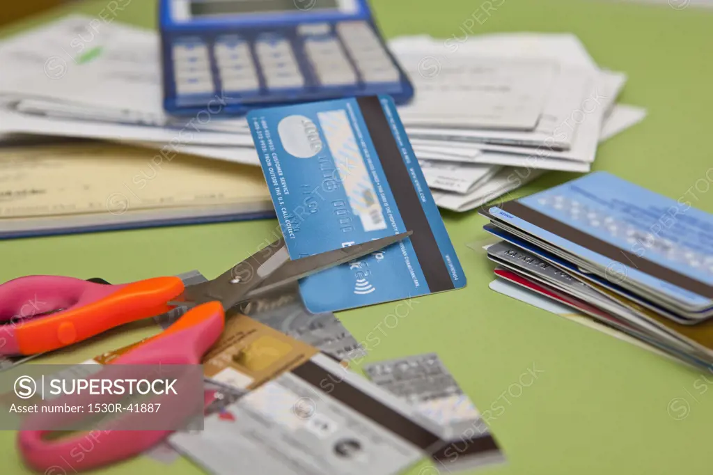 Scissors cutting up credit cards