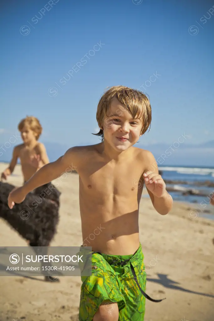 Children running on beach with dog  SayulitaMexico