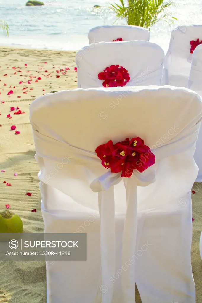 Chairs on beach decorated for wedding,  Sayulita, Mexico