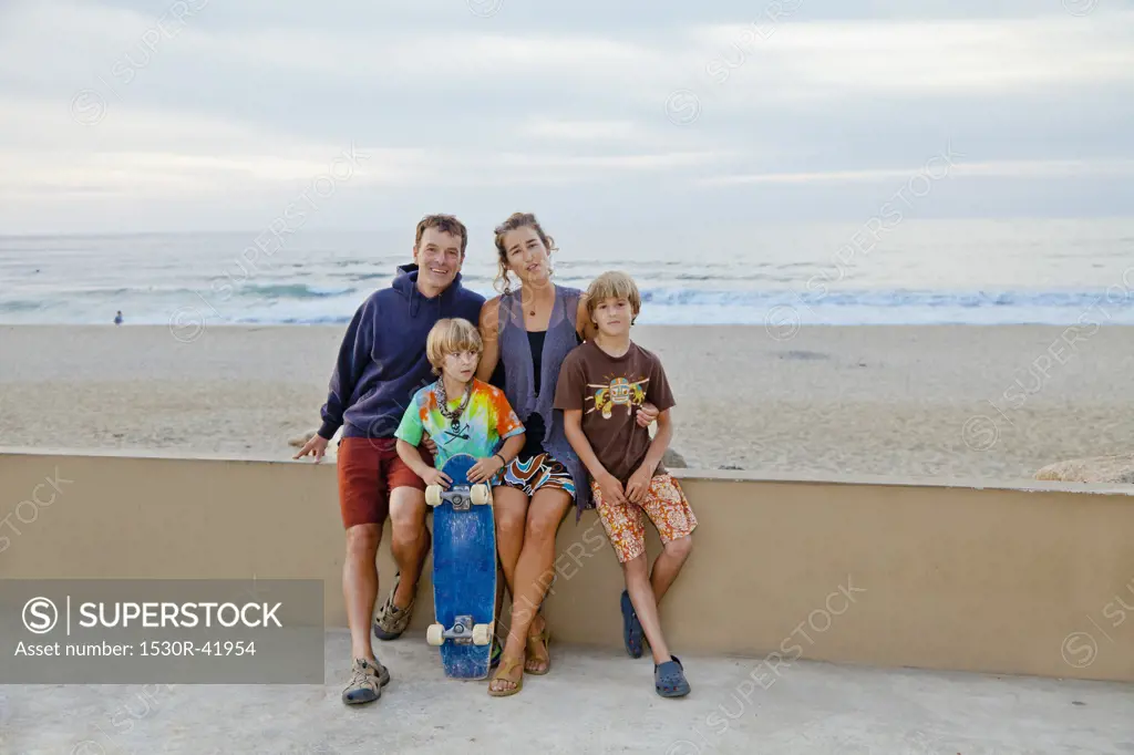 Man and woman with two boys on beach boardwalk,  Sayulita, Mexico