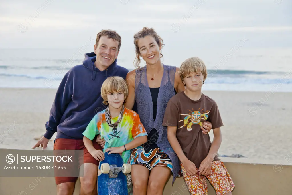 Man and woman with two boys on beach boardwalk,  Sayulita, Mexico
