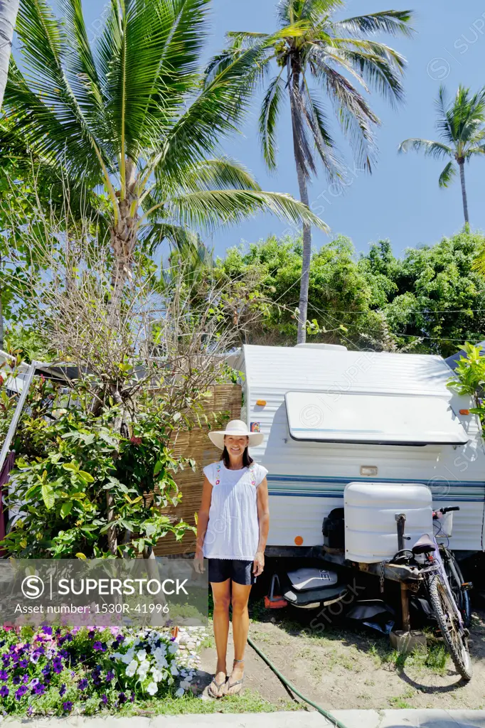 Woman standing in garden with camper,  Sayulita, Mexico