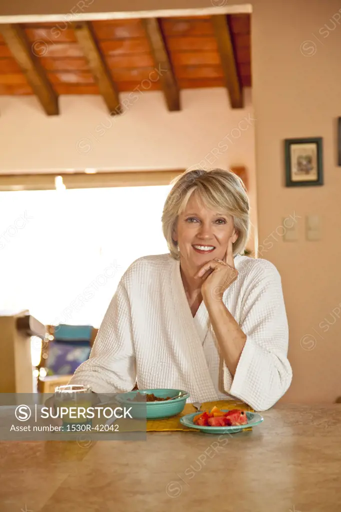Woman seated at counter eating healthy breakfast