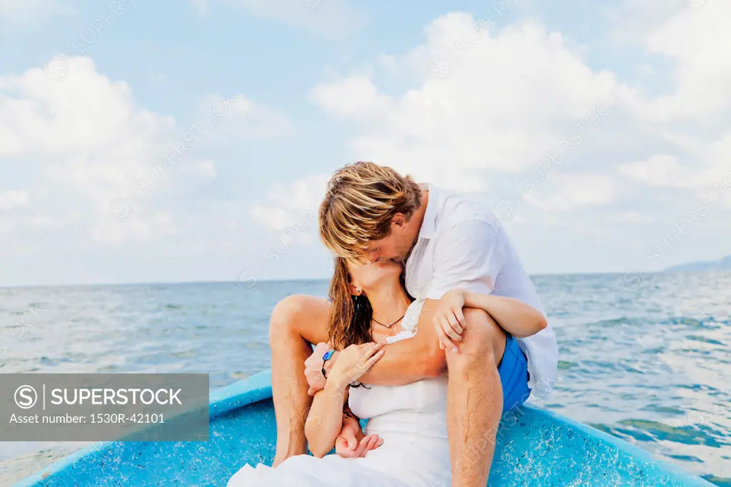 Man and woman embracing in bow of boat