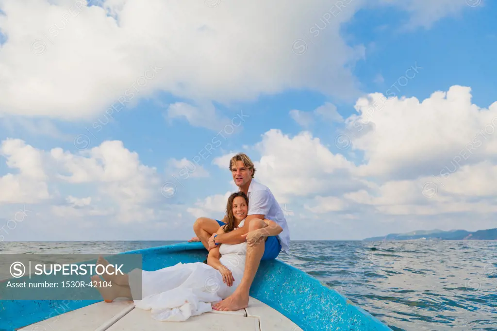 Man and woman embracing in bow of boat