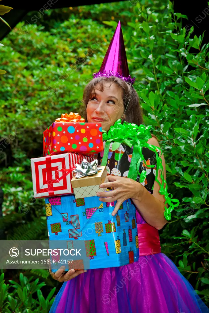 Woman in party clothes holding presents