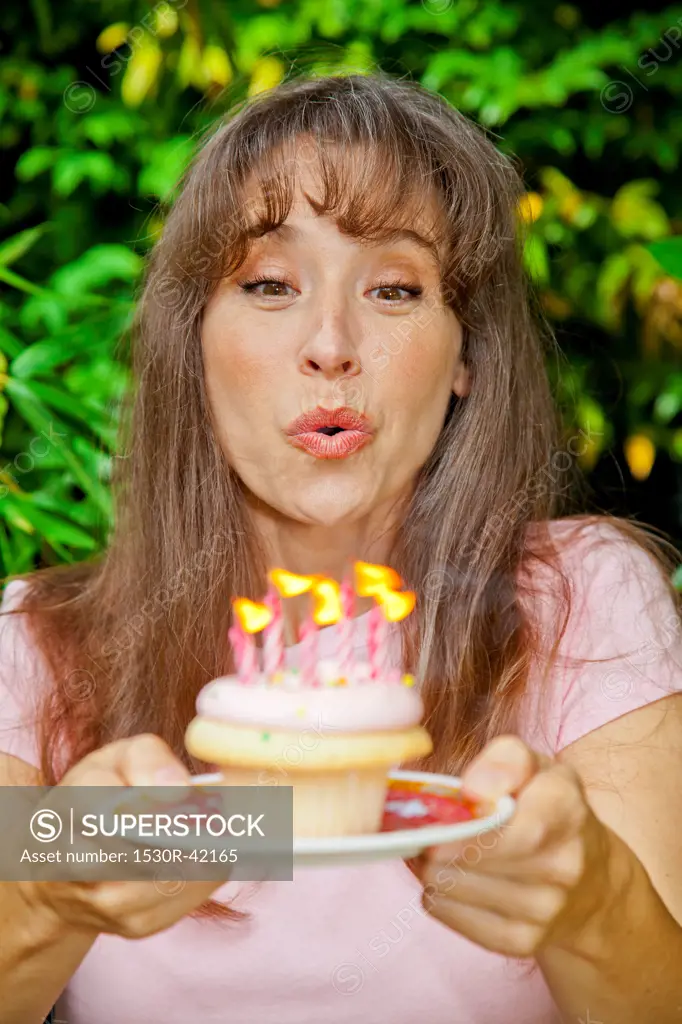 Woman with birthday cupcake