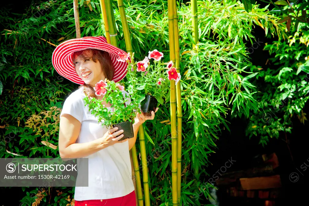 Woman holding plants outdoors