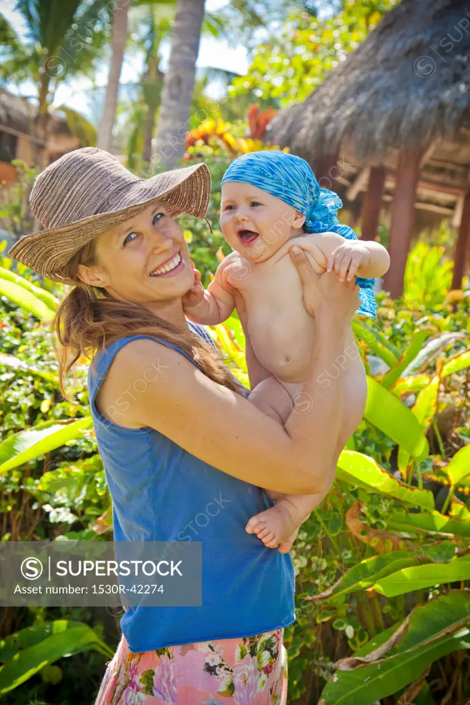 Smiling woman holding baby