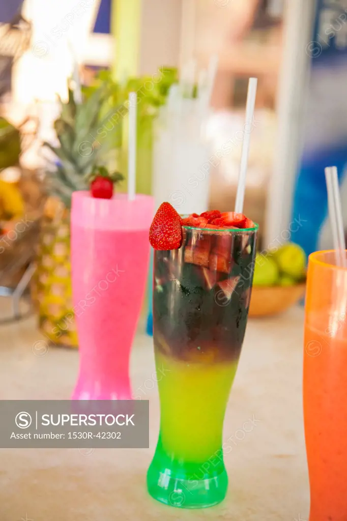 Row of colorful drinks on counter