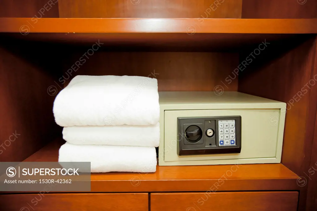 Towels stacked next to hotel safe