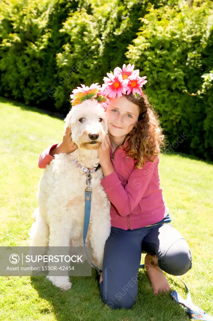 Teen girl and white dog wearing flowers