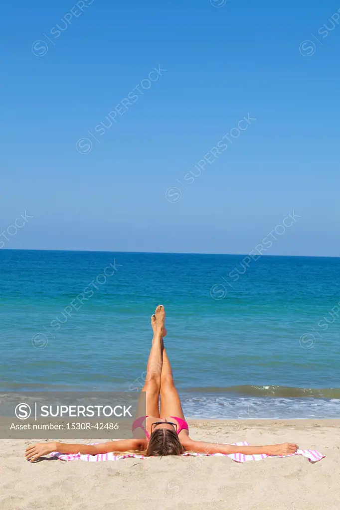 Woman on beach enjoying sun