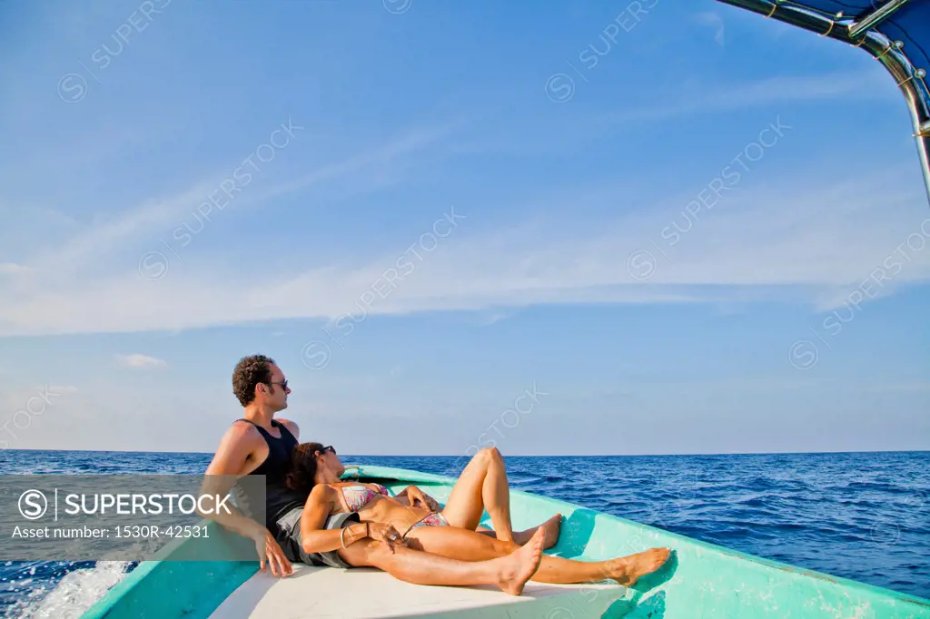 Man and woman relaxing in bow of boat