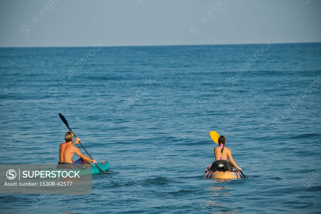 Couple kayaking in ocean